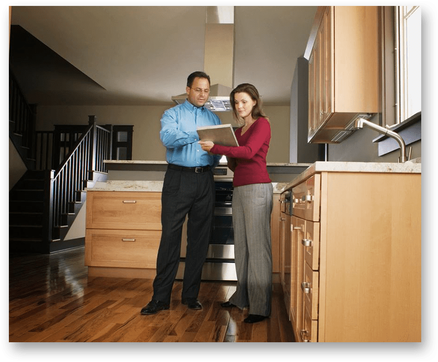 A man and woman standing in front of an oven.