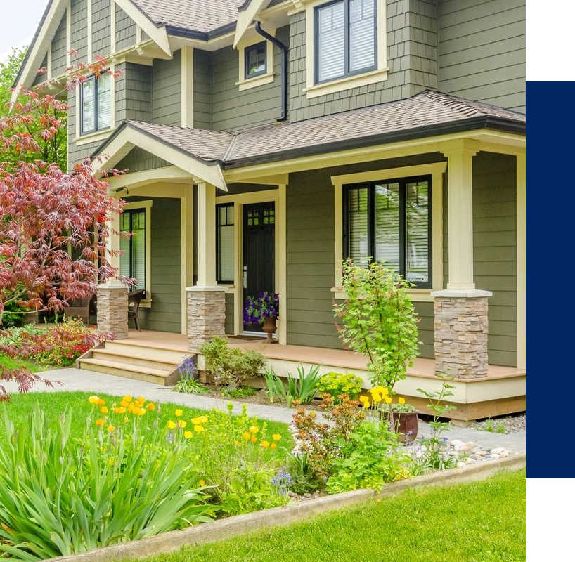 A house with flowers and grass in front of it.